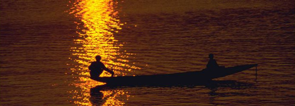 Boatman At Sunset In Hue Vietnam